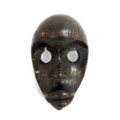 An early 20th century African Dan mask 16cm wide 23cm high