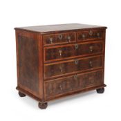 A William and Mary walnut and oyster veneered chest of two short and three long drawers with brass