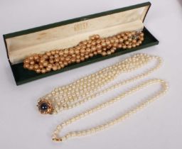 Three boxed cultured pearl necklaces, one with a 14 carat gold clasp, another 9 carat gold