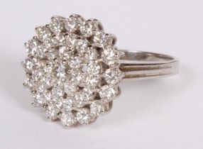 A 14 carat white gold diamond cluster ring, marked 585, central diamond 0.33 carats, size Q, 7.7g