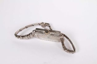 An Art Deco diamond encrusted platinum ladies tank type cocktail wristwatch, the rectangular dial