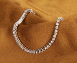 An 18 carat white gold diamond tennis bracelet, approximately 5.0 carats total, each stone