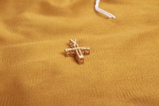 An 18 carat yellow gold Tiffany style diamond crucifix pendant, approximately 1.0 carats total, 2.