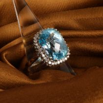 An 18 carat white gold aquamarine and diamond cluster ring, size R, 9.7g