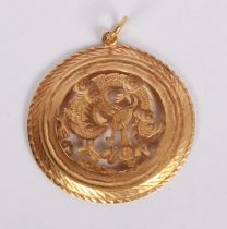 A Chinese yellow metal pierced circular dragon pendant, 12g