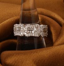 An 18 carat white gold diamond dress ring, set with both brilliant and baguette cut stones,