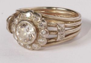 A 14 carat white gold flower cluster ring, marked 585, central diamond is .75 carat with a melee