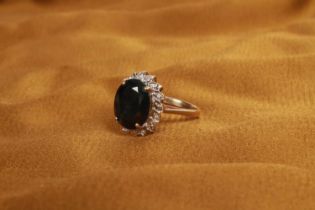 A 9 carat yellow gold sapphire and diamond cluster ring, the central stone approximately 3.0 carats,