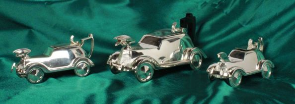 A silver plated three piece tea set, in the form of vintage cars, H:32cm W:19cm