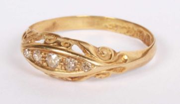 An 18 carat yellow gold diamond five stone ring, in a carved boat shaped setting, size T, 2.0g