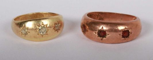 An 18 carat yellow gold diamond three stone gypsy ring, size S, 4.3g, together with a similar