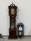 A modern longcase clock and a wall clock