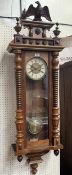 A Vienna style walnut cased wall clock with two train spring barrel movement. 53½in high