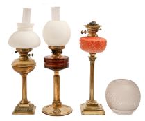 A Victorian brass oil lamp, the Corinthian style column with moulded glass font and twin duplex
