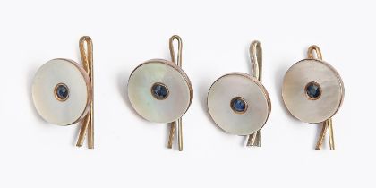 A set of four sapphire and mother-of-pearl buttons, early 20th c, in giltmetal, 1.4cm diam Condition