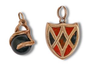 A Victorian shield-shaped gold, bloodstone and cornelian locket, c1900, 2.4cm h and a bloodstone