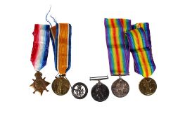 Five WWI medals and a Services Rendered badge.