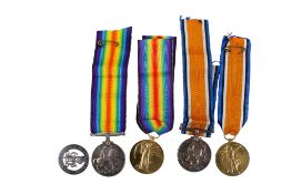 Two pairs of WWI British campaign 'Victory' and 'War' medals plus a 'Services Rendered badge'.