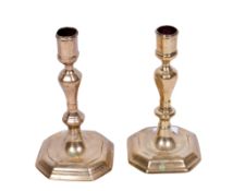 A pair of period brass candlesticks. Mounted on stepped octagonal bases, H21.5cm.