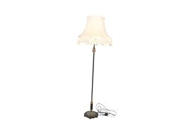 An early 20th century Japanned and gilt metal standard lamp with shade. Raised on a circular base.
