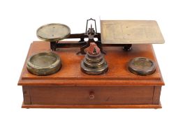 A set of Parkins & Gotts brass postal scales and weights.