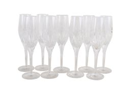 A set of nine Stuart glass champagne flutes.