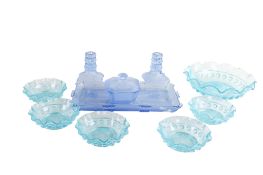 A collection of coloured pressed glassware.