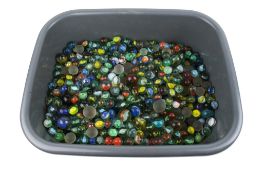 A large collection of assorted glass marbles. Of various sizes and colour.