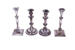 Two pairs of silver plated candlesticks.