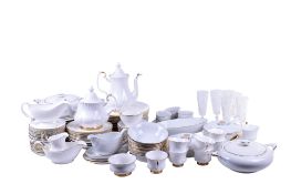 An extensive matched white porcelain dinner and tea service and a set of glasses.
