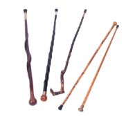 Five wooden walking sticks.