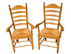 A pair of vintage ladder back kitchen chairs.