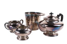 A silverplated three-piece tea set and an ice bucket.