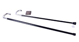 Two white metal handled walking canes and a cigarette case.