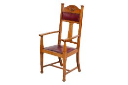 A circa 1900 Arts and Crafts oak framed open armchair in the manner of Liberty & Co.