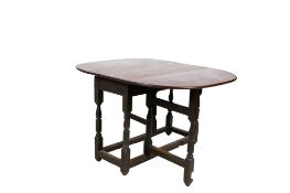 A 19th century gateleg dining table with a later top.
