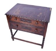 A carved oak writing table.