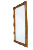 A large antique style gilt framed rectangular wall mirror.