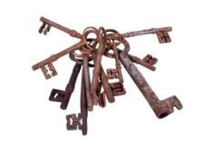 A collection of vintage cast metal keys. Of various sizes and designs, attached to a ring.