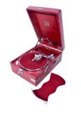A vintage His Master's Voice portable gramophone. In a red leather case. L41cm.