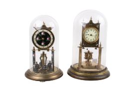Two lacquered brass anniversary clocks beneath glass domes.