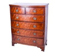A Victorian inlaid mahogany bow fronted chest of drawers.