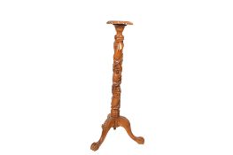 A 20th century carved mahogany torchiere.