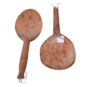 A vintage butter paddle and a wooden spoon.