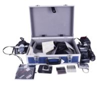 A collection of assorted photographic film and digital cameras with accessories.