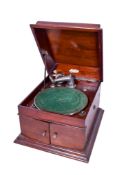 An early 20th century Itonia wind up gramophone. In a mahogany case, H33cm x W43cm x D50cm.