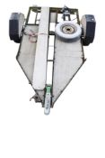 A motorcycle trailer. Having a metal frame and reflector lights to the back, L235cm.