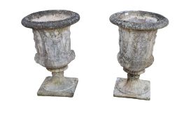 A pair of large composite stone garden urns.