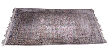 A Turkish Oushak style wool rug on a cream ground.