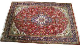A large Persian style wool rug.